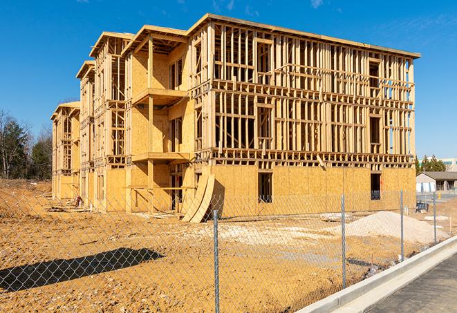 workers protected by temporary barrier fence during building maintenance in North Tustin, CA